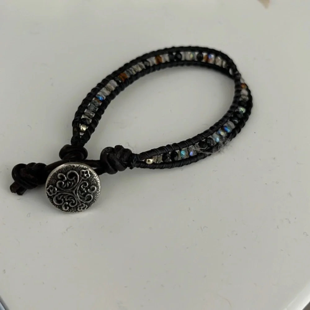 Black beaded rope bracelet with Celtic emblem